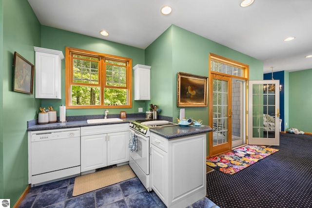 kitchen featuring white appliances, sink, french doors, and white cabinetry