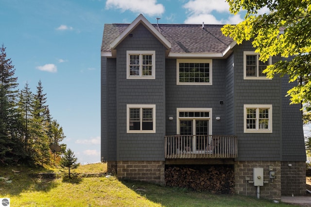 back of house featuring a deck and a yard