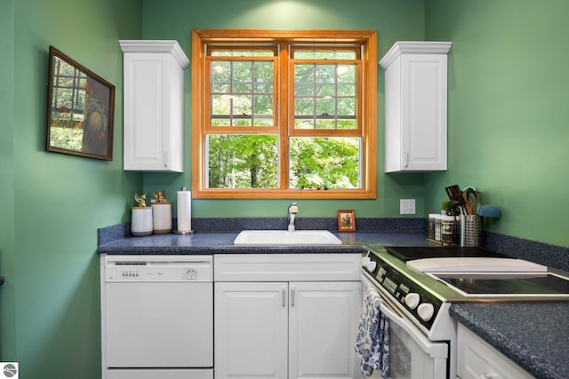 kitchen with white appliances, white cabinets, and sink