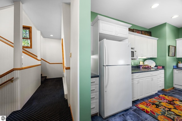 kitchen with white appliances and white cabinetry