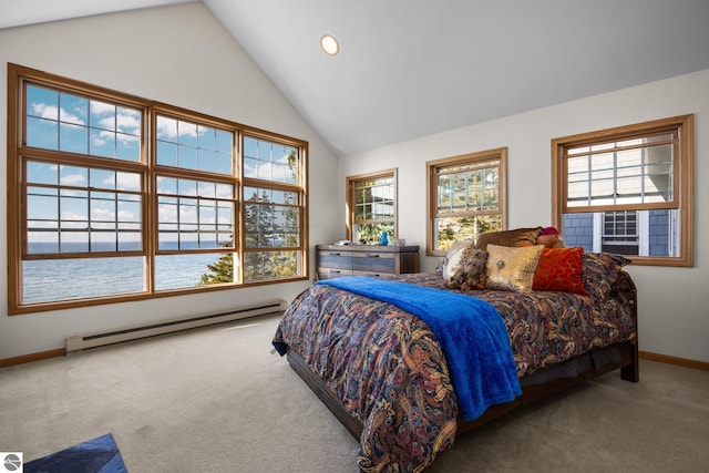 bedroom featuring baseboard heating, multiple windows, carpet floors, and a water view