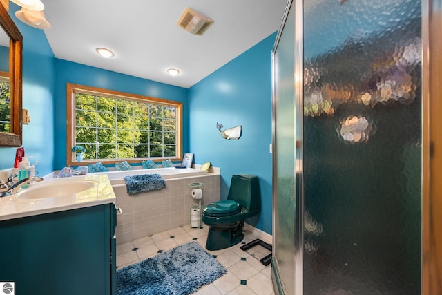 bathroom with toilet, tile patterned flooring, a shower with shower door, and vanity