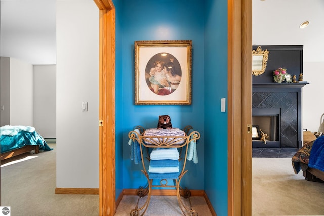 hall featuring carpet flooring and a baseboard heating unit