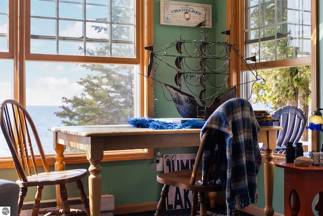 dining room with plenty of natural light and a water view