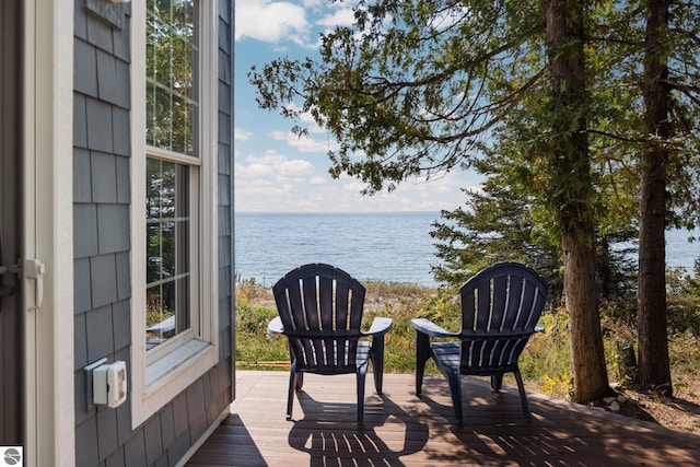 wooden terrace featuring a water view