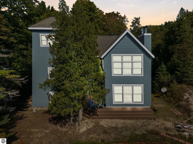 view of back house at dusk