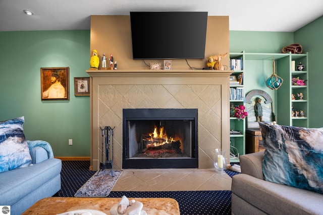 living room featuring a tiled fireplace