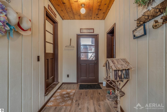 entryway with wooden ceiling, wooden walls, and wood-type flooring