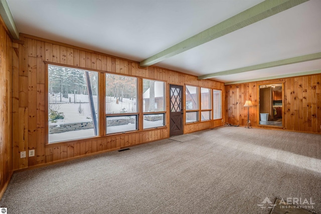 interior space with beam ceiling and carpet