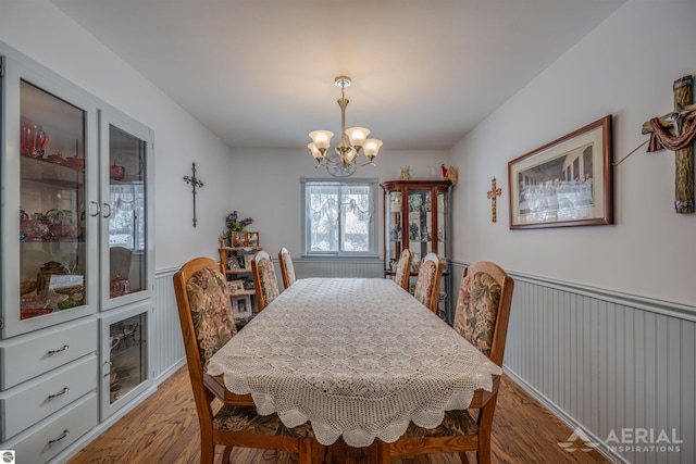 dining room with a notable chandelier and hardwood / wood-style flooring