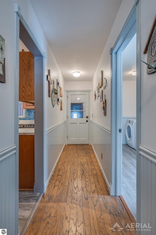 hallway with hardwood / wood-style floors and washer / clothes dryer