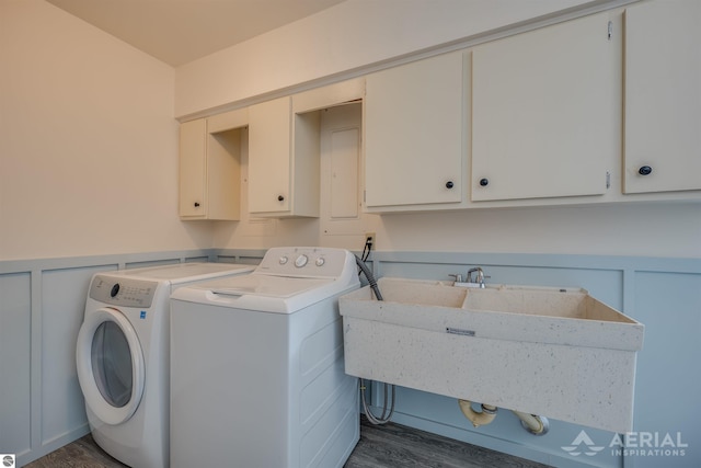 clothes washing area with sink, separate washer and dryer, cabinets, and dark hardwood / wood-style floors