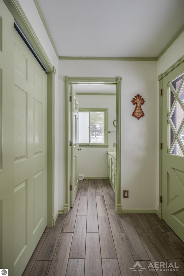 interior space with light wood-type flooring and crown molding