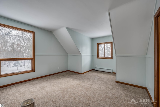 bonus room featuring lofted ceiling, a baseboard radiator, and light colored carpet