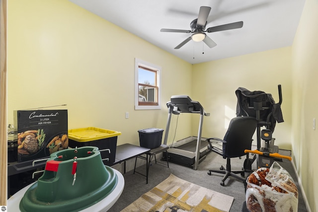 workout area with ceiling fan and carpet floors