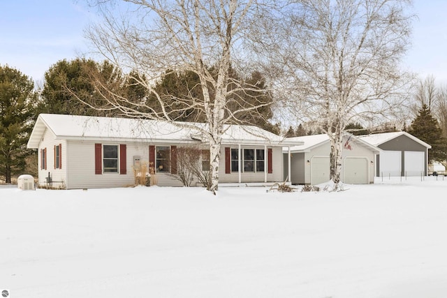 single story home featuring a garage and an outbuilding