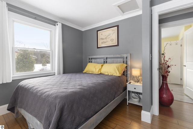 bedroom featuring ornamental molding and hardwood / wood-style flooring