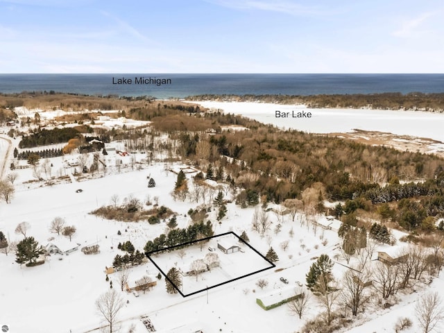 snowy aerial view featuring a water view