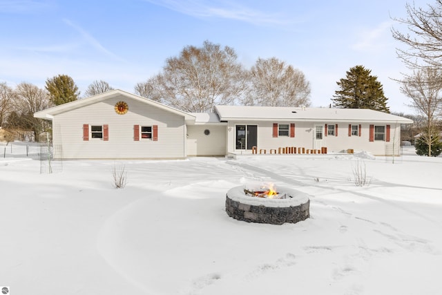 snow covered property with a fire pit