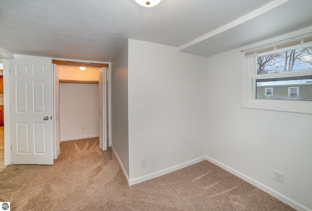 unfurnished room with light carpet