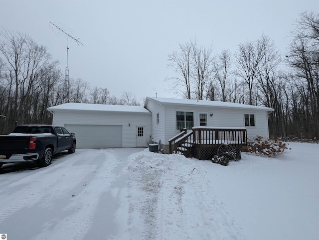 manufactured / mobile home with a deck and a garage
