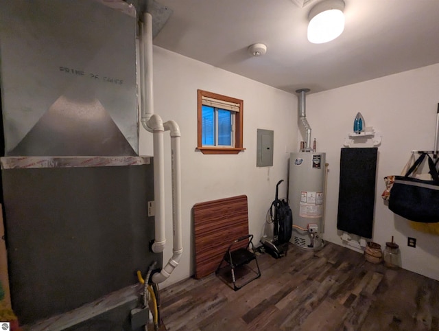miscellaneous room featuring water heater, dark wood-type flooring, and electric panel