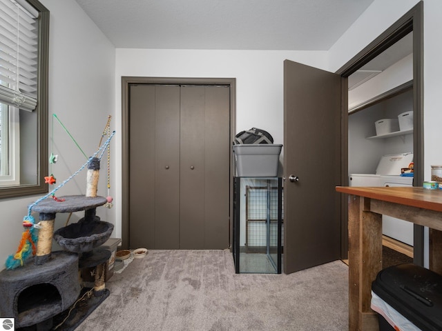 office area with light colored carpet and washer / clothes dryer