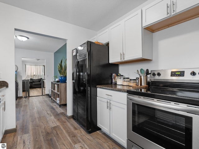 kitchen with electric stove, white cabinets, black refrigerator with ice dispenser, and dark wood-type flooring