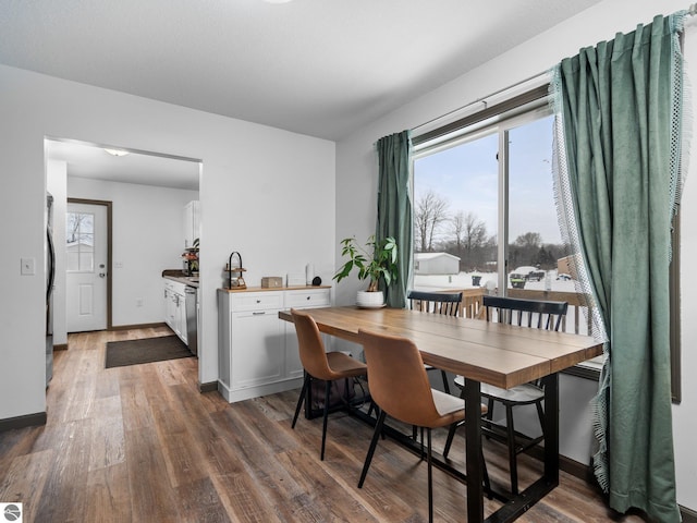 dining space featuring dark wood-type flooring