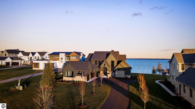 exterior space with a residential view, a water view, and a chimney