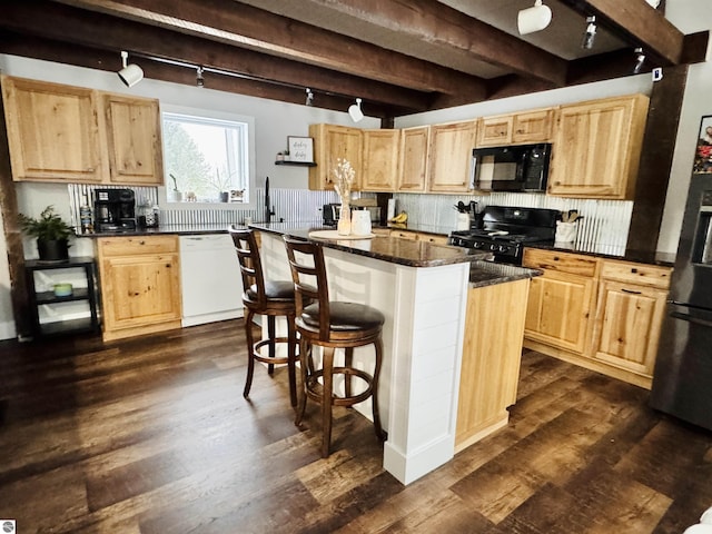 kitchen featuring a kitchen island, black appliances, a breakfast bar, beamed ceiling, and dark wood-type flooring