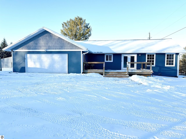 single story home with a garage and a wooden deck