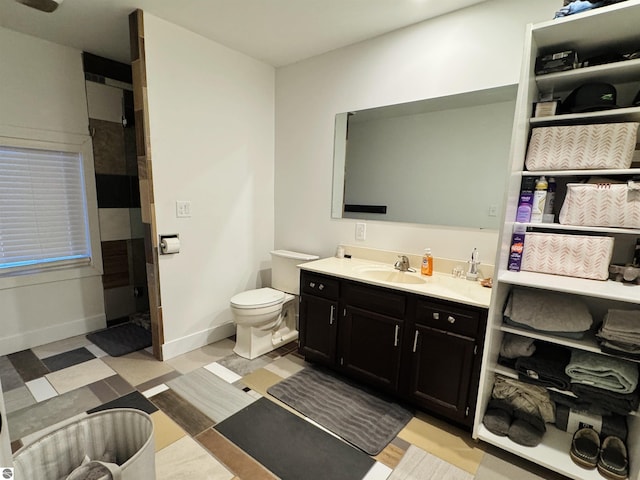 bathroom featuring toilet and vanity