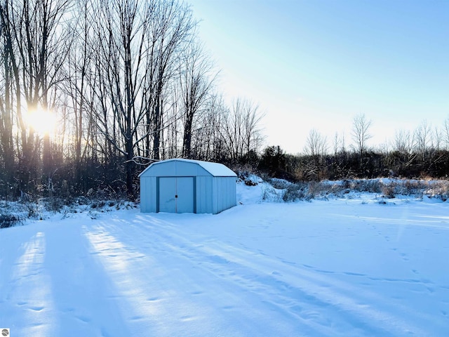 snowy yard with a shed