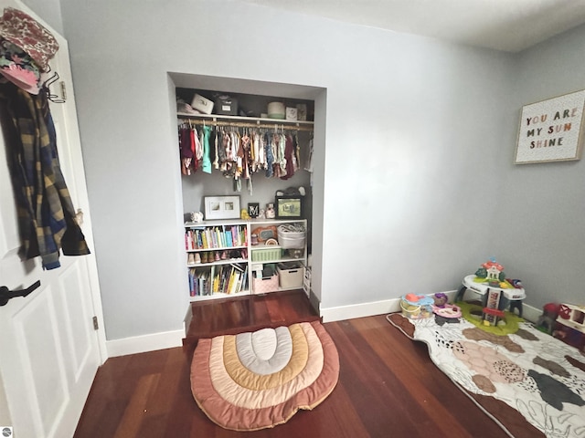 bedroom featuring dark wood-type flooring and a closet