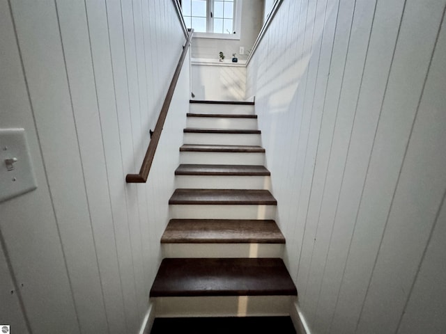 staircase with wood walls