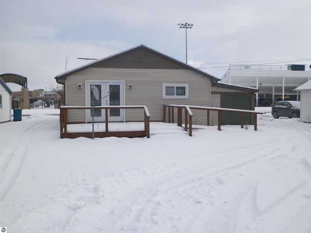 view of snow covered back of property