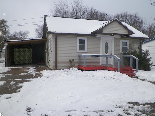 bungalow-style house featuring a carport