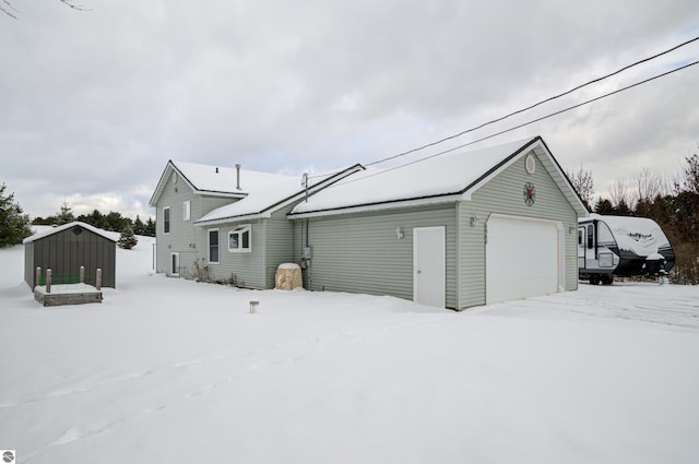 exterior space featuring a garage and a storage shed