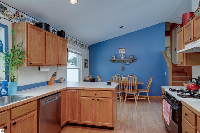 kitchen with kitchen peninsula, light wood-type flooring, gas range, dishwasher, and pendant lighting