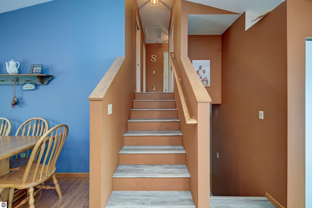 staircase with hardwood / wood-style flooring