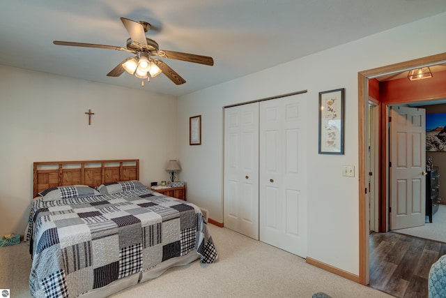 bedroom with ceiling fan, a closet, and hardwood / wood-style flooring