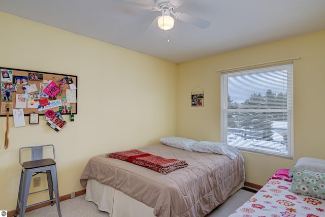 bedroom with ceiling fan and light carpet