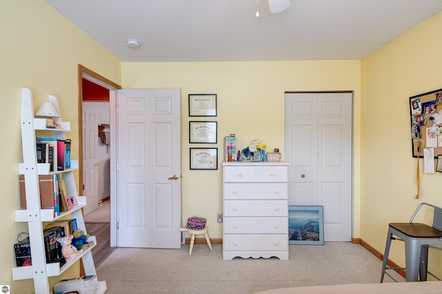 bedroom featuring light colored carpet and a closet