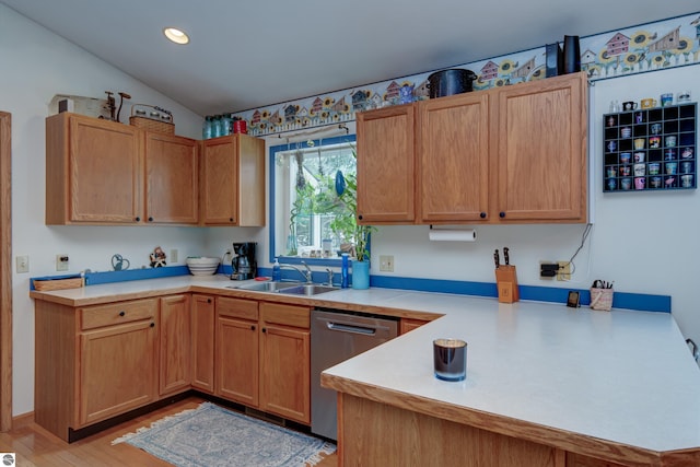 kitchen featuring dishwasher, lofted ceiling, sink, kitchen peninsula, and light wood-type flooring