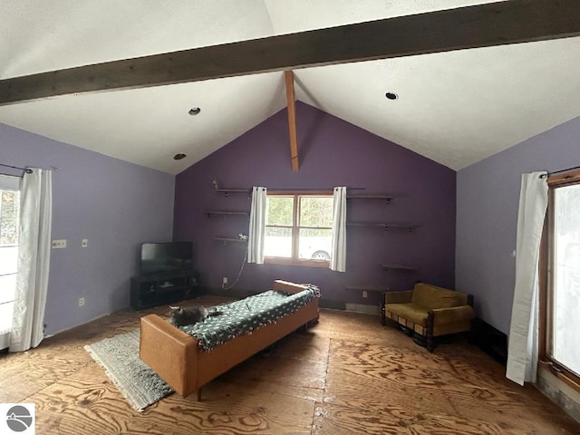 bedroom featuring lofted ceiling and multiple windows