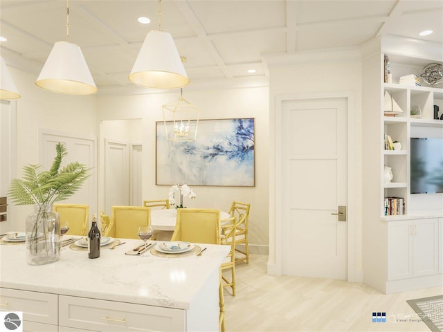 kitchen with coffered ceiling, light wood-type flooring, pendant lighting, white cabinets, and built in shelves