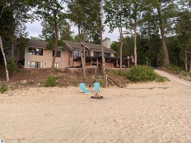 view of playground with a deck and a fire pit