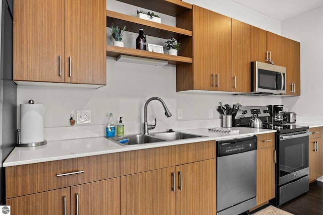 kitchen featuring stainless steel appliances, dark hardwood / wood-style floors, and sink