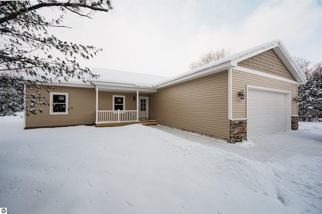 view of front of house featuring a porch and a garage